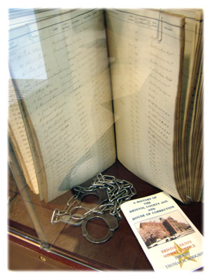 image of inmate log book and handcuffs
